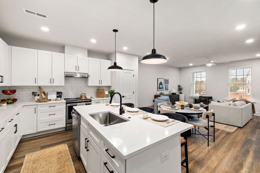 Large kitchen island with stainless steel appliances at HARMON Jefferson Village